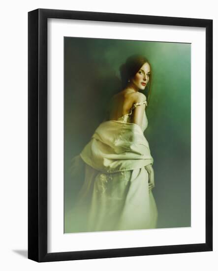 A Woman in a White Evening Dress, Standing by the Wall and Looking at the Viewer-Malgorzata Maj-Framed Photographic Print