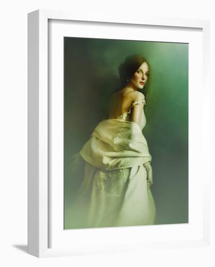 A Woman in a White Evening Dress, Standing by the Wall and Looking at the Viewer-Malgorzata Maj-Framed Photographic Print