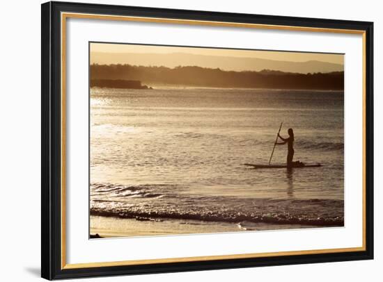 A Woman on a Stand-Up Paddleboard Heads Towards Main Beach, Noosa, at Sunset-William Gray-Framed Photographic Print