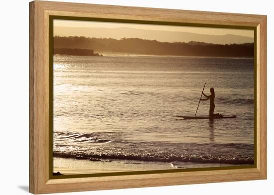 A Woman on a Stand-Up Paddleboard Heads Towards Main Beach, Noosa, at Sunset-William Gray-Framed Premier Image Canvas