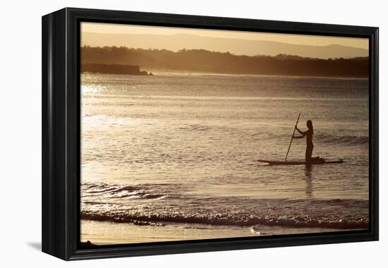 A Woman on a Stand-Up Paddleboard Heads Towards Main Beach, Noosa, at Sunset-William Gray-Framed Premier Image Canvas