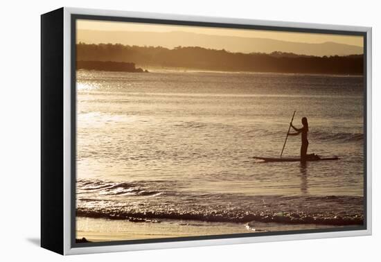 A Woman on a Stand-Up Paddleboard Heads Towards Main Beach, Noosa, at Sunset-William Gray-Framed Premier Image Canvas