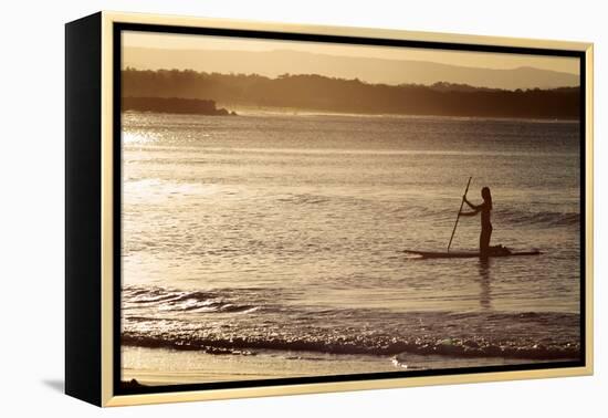 A Woman on a Stand-Up Paddleboard Heads Towards Main Beach, Noosa, at Sunset-William Gray-Framed Premier Image Canvas