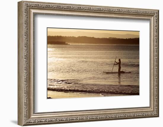 A Woman on a Stand-Up Paddleboard Heads Towards Main Beach, Noosa, at Sunset-William Gray-Framed Photographic Print