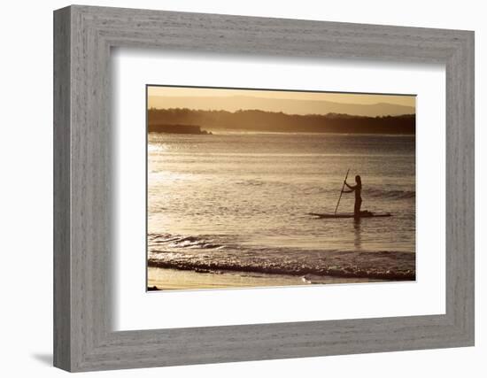 A Woman on a Stand-Up Paddleboard Heads Towards Main Beach, Noosa, at Sunset-William Gray-Framed Photographic Print