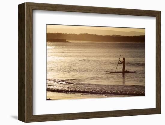 A Woman on a Stand-Up Paddleboard Heads Towards Main Beach, Noosa, at Sunset-William Gray-Framed Photographic Print
