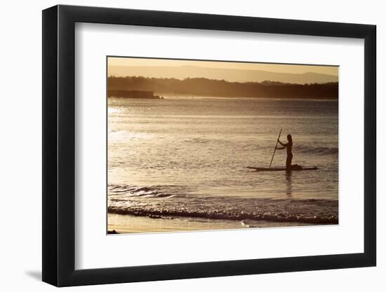 A Woman on a Stand-Up Paddleboard Heads Towards Main Beach, Noosa, at Sunset-William Gray-Framed Photographic Print