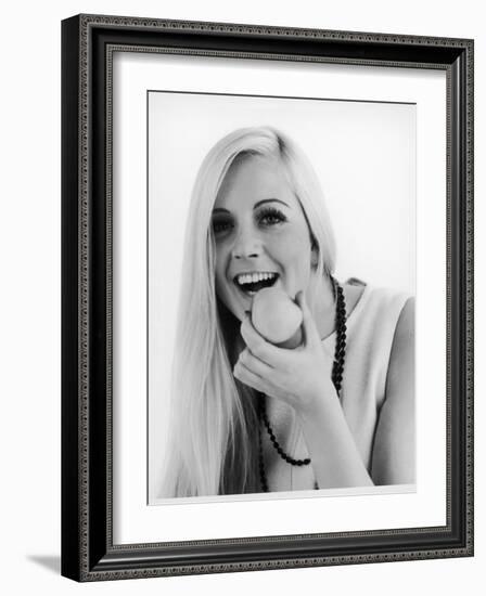 A Woman Poses Holding an Apple Up to Her Mouth-null-Framed Photographic Print