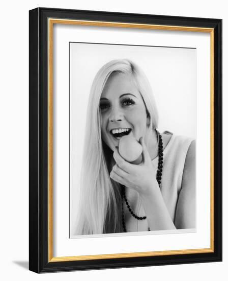 A Woman Poses Holding an Apple Up to Her Mouth-null-Framed Photographic Print