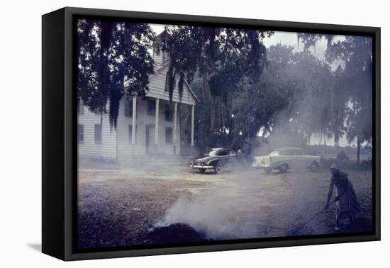 A Woman Rakes and Burns Brush in Front of a Church on Edisto Island, South Carolina, 1956-Walter Sanders-Framed Premier Image Canvas