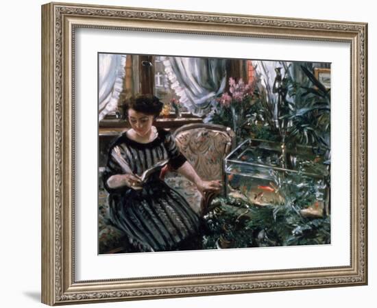 A Woman Reading Near a Goldfish Tank-Lovis Corinth-Framed Giclee Print