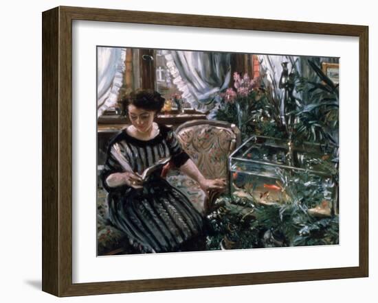 A Woman Reading Near a Goldfish Tank-Lovis Corinth-Framed Giclee Print