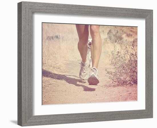 A Woman Running on a Trail with a Dog-graphicphoto-Framed Photographic Print