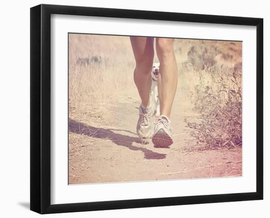 A Woman Running on a Trail with a Dog-graphicphoto-Framed Photographic Print