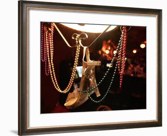 A Woman's High Heeled Shoe Hangs with Some Mardi Gras Beads-null-Framed Photographic Print