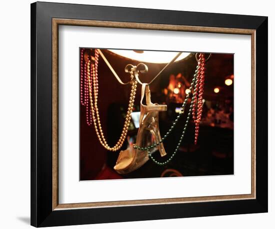 A Woman's High Heeled Shoe Hangs with Some Mardi Gras Beads-null-Framed Photographic Print