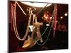 A Woman's High Heeled Shoe Hangs with Some Mardi Gras Beads-null-Mounted Photographic Print