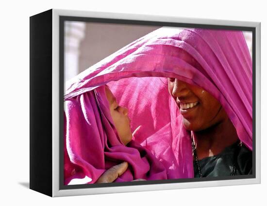 A Woman Shields Her Child from the Sun Using Her Scarf-null-Framed Premier Image Canvas