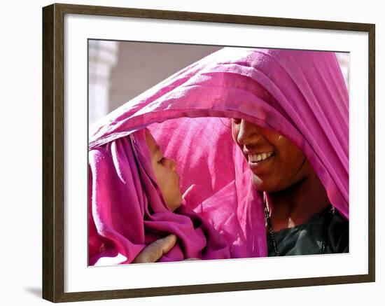 A Woman Shields Her Child from the Sun Using Her Scarf-null-Framed Photographic Print