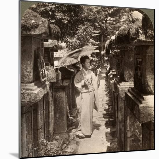 A Woman Shinto Devotee Counting the Stone Lanterns, Kasuga Shrine, Nara, Japan, 1904-Underwood & Underwood-Mounted Photographic Print