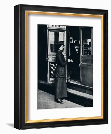 A woman ticket inspector at work, c1914-Unknown-Framed Photographic Print