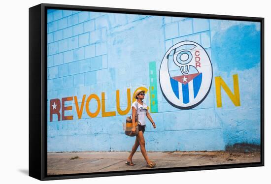 A Woman Walks Past A Propagandistic Mural In Cienfuegos, Cuba-Erik Kruthoff-Framed Stretched Canvas