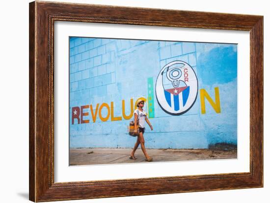 A Woman Walks Past A Propagandistic Mural In Cienfuegos, Cuba-Erik Kruthoff-Framed Photographic Print