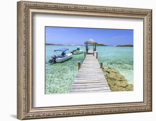 A Wood Pier Leads to Moored Boats and Clear Tropical Waters Near Staniel Cay, Exuma, Bahamas-James White-Framed Photographic Print