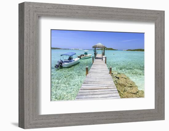 A Wood Pier Leads to Moored Boats and Clear Tropical Waters Near Staniel Cay, Exuma, Bahamas-James White-Framed Photographic Print