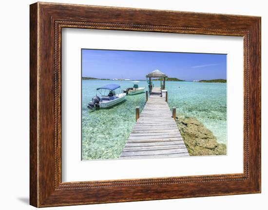 A Wood Pier Leads to Moored Boats and Clear Tropical Waters Near Staniel Cay, Exuma, Bahamas-James White-Framed Photographic Print