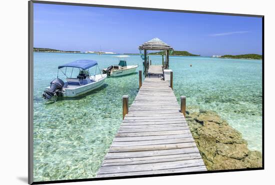 A Wood Pier Leads to Moored Boats and Clear Tropical Waters Near Staniel Cay, Exuma, Bahamas-James White-Mounted Photographic Print