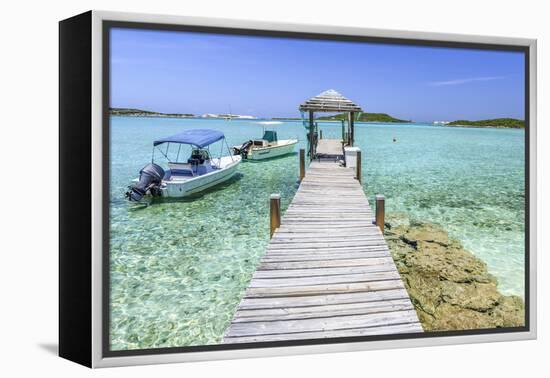 A Wood Pier Leads to Moored Boats and Clear Tropical Waters Near Staniel Cay, Exuma, Bahamas-James White-Framed Premier Image Canvas