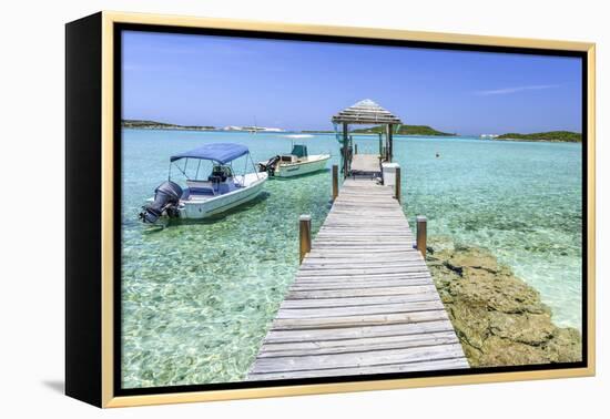 A Wood Pier Leads to Moored Boats and Clear Tropical Waters Near Staniel Cay, Exuma, Bahamas-James White-Framed Premier Image Canvas