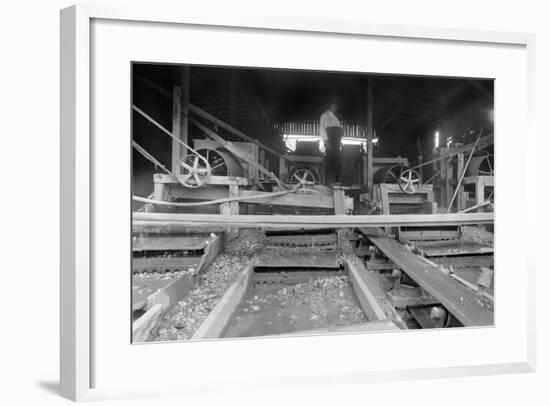 A Worker Stands over a Rock or Gravel Processing Facility, Ca. 1910-null-Framed Photographic Print