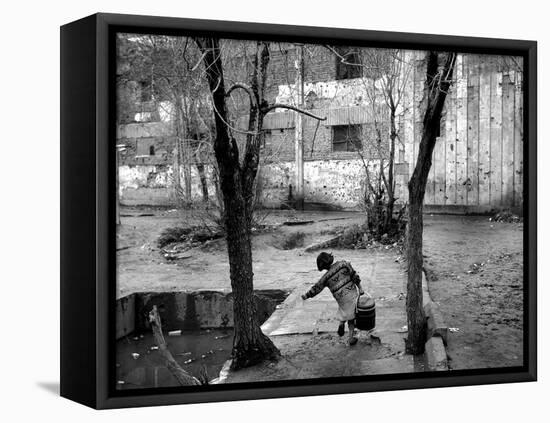 A Young Afghan Girl Carries Water from a Well to Her Family-null-Framed Premier Image Canvas