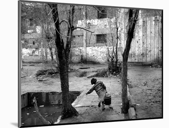 A Young Afghan Girl Carries Water from a Well to Her Family-null-Mounted Photographic Print