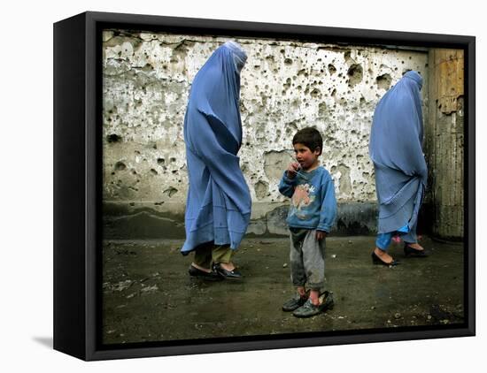 A Young Afghan Refugee Boy Stands in a Pair of Adult's Shoes-null-Framed Premier Image Canvas