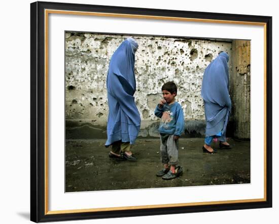 A Young Afghan Refugee Boy Stands in a Pair of Adult's Shoes-null-Framed Photographic Print