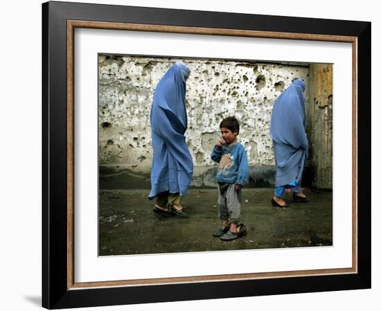 A Young Afghan Refugee Boy Stands in a Pair of Adult's Shoes-null-Framed Photographic Print