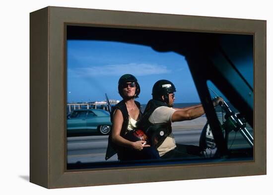 A Young Biker Sitting on the Motorbike Saddle with His Companion-Mario de Biasi-Framed Premier Image Canvas