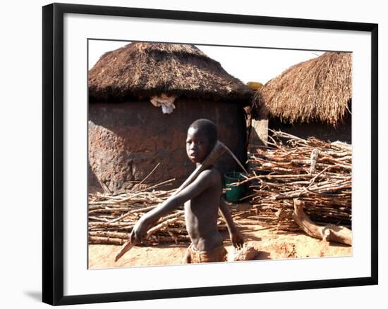 A Young Boy Carries a Hoe-null-Framed Photographic Print