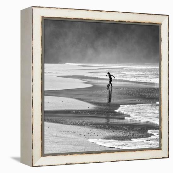 A Young Boy Kicks a Ball on Itamambuca Beach in Ubatuba, Brazil-Alex Saberi-Framed Premier Image Canvas