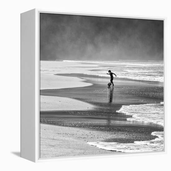 A Young Boy Kicks a Ball on Itamambuca Beach in Ubatuba, Brazil-Alex Saberi-Framed Premier Image Canvas