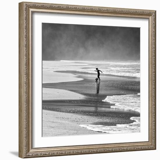 A Young Boy Kicks a Ball on Itamambuca Beach in Ubatuba, Brazil-Alex Saberi-Framed Photographic Print