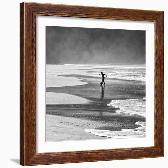 A Young Boy Kicks a Ball on Itamambuca Beach in Ubatuba, Brazil-Alex Saberi-Framed Photographic Print