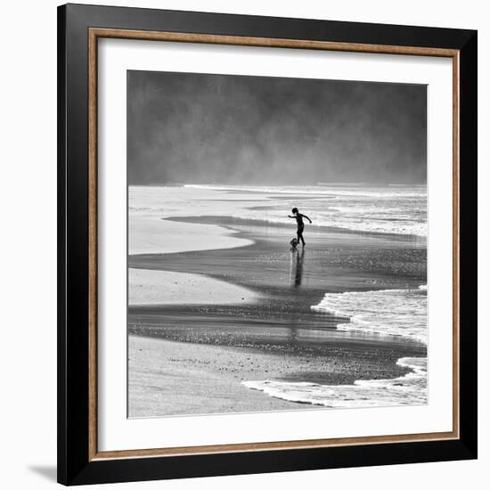 A Young Boy Kicks a Ball on Itamambuca Beach in Ubatuba, Brazil-Alex Saberi-Framed Photographic Print