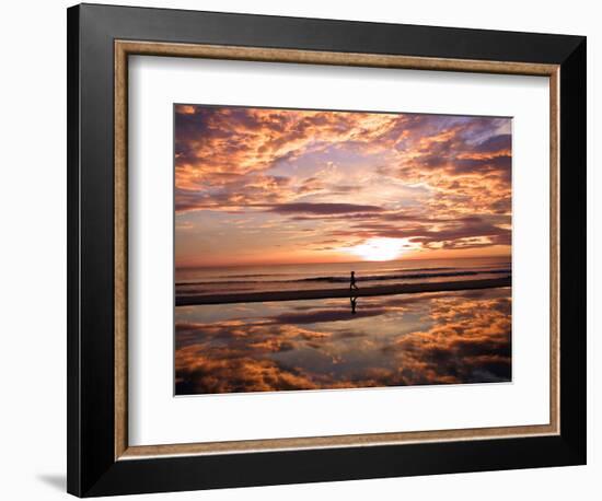 A Young Boy Takes an Early Morning Jog as the Sun Rises Along China Beach-null-Framed Photographic Print