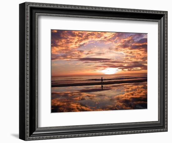 A Young Boy Takes an Early Morning Jog as the Sun Rises Along China Beach-null-Framed Photographic Print