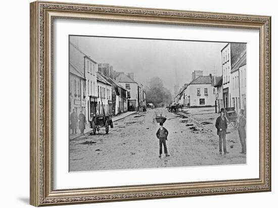 A Young Delivery Boy Stands Nonchalantly in the Main Street of Clonmorris-Thomas Wynne-Framed Giclee Print