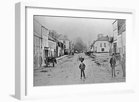 A Young Delivery Boy Stands Nonchalantly in the Main Street of Clonmorris-Thomas Wynne-Framed Giclee Print